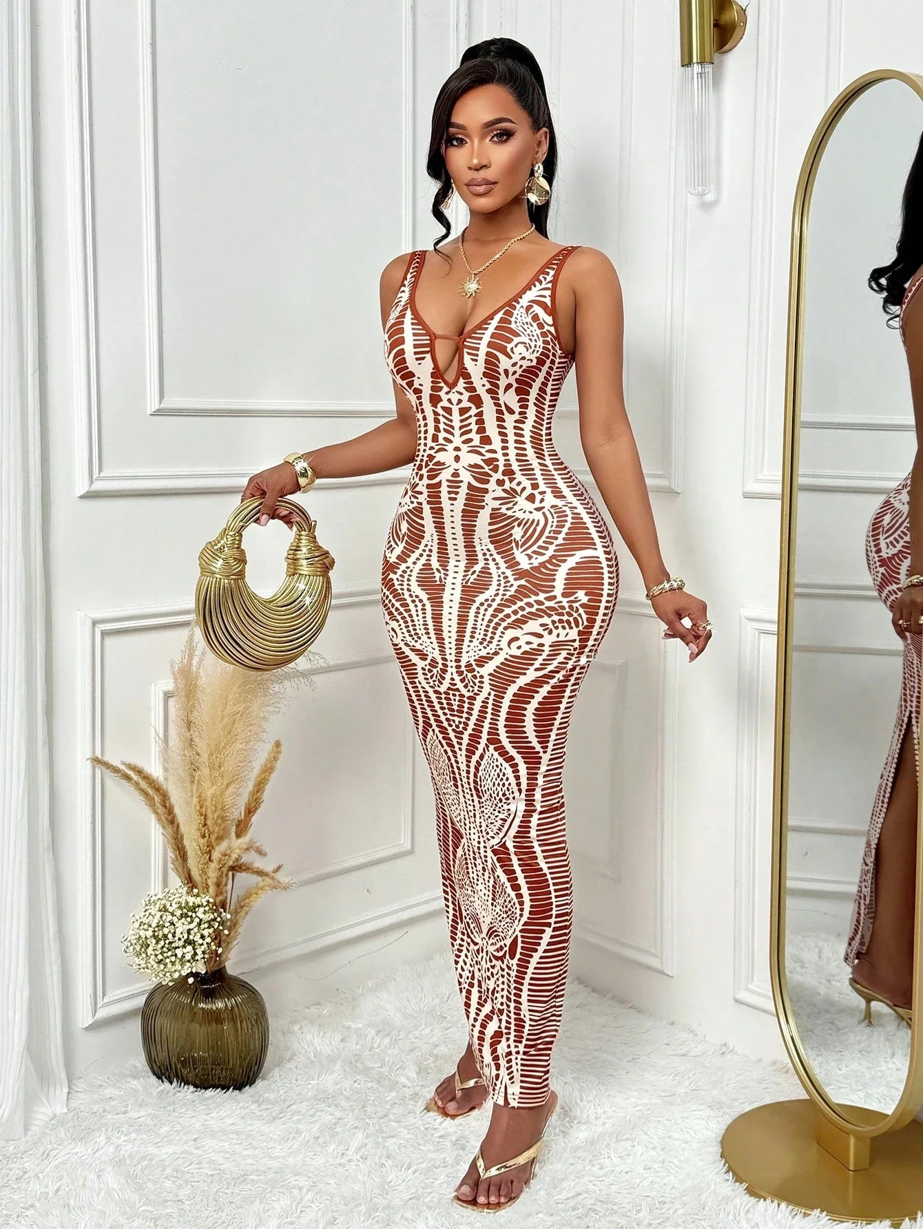 Woman in a patterned dress standing in a stylish room with decor elements.