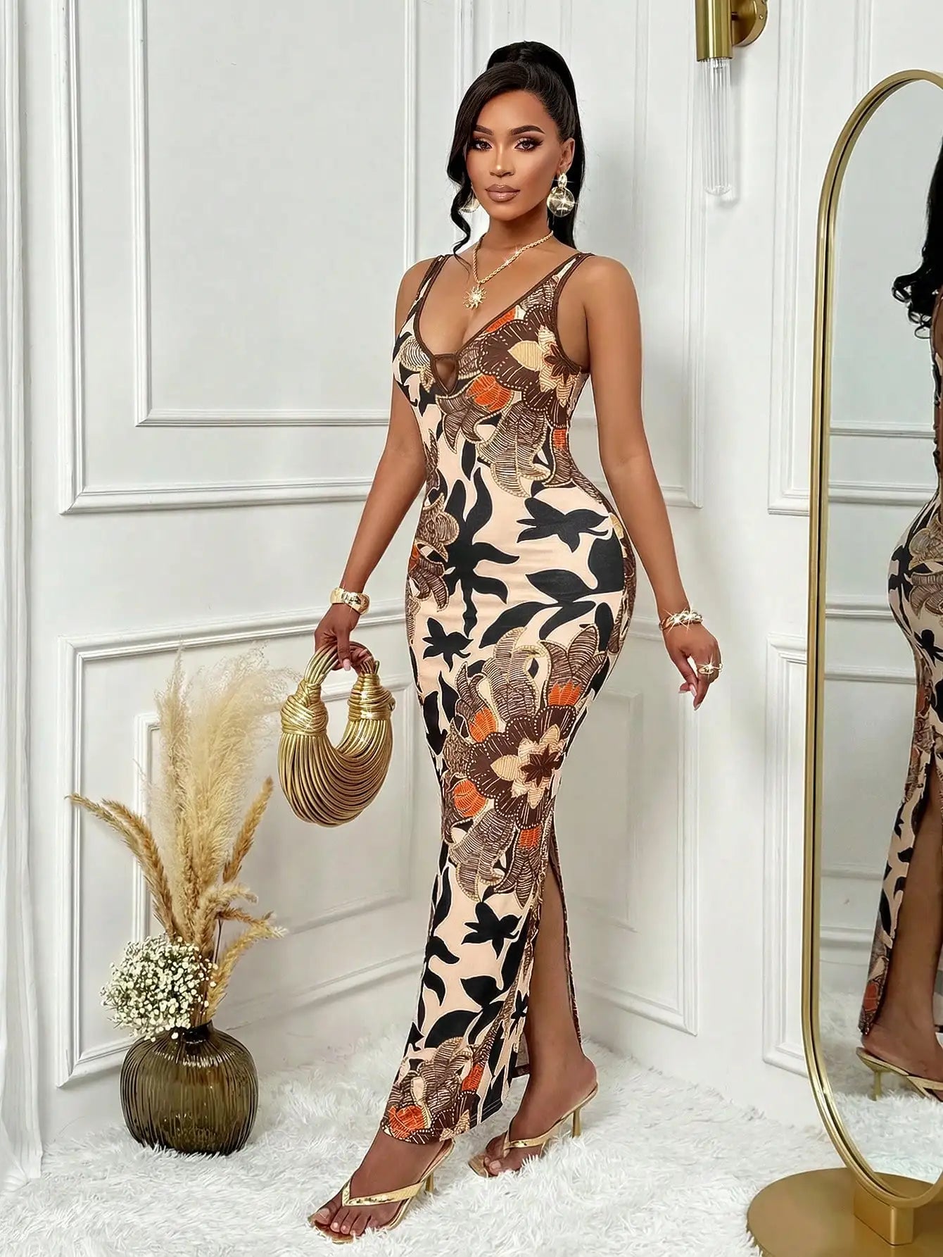 Woman in a floral dress standing in a stylish room with decorative elements.