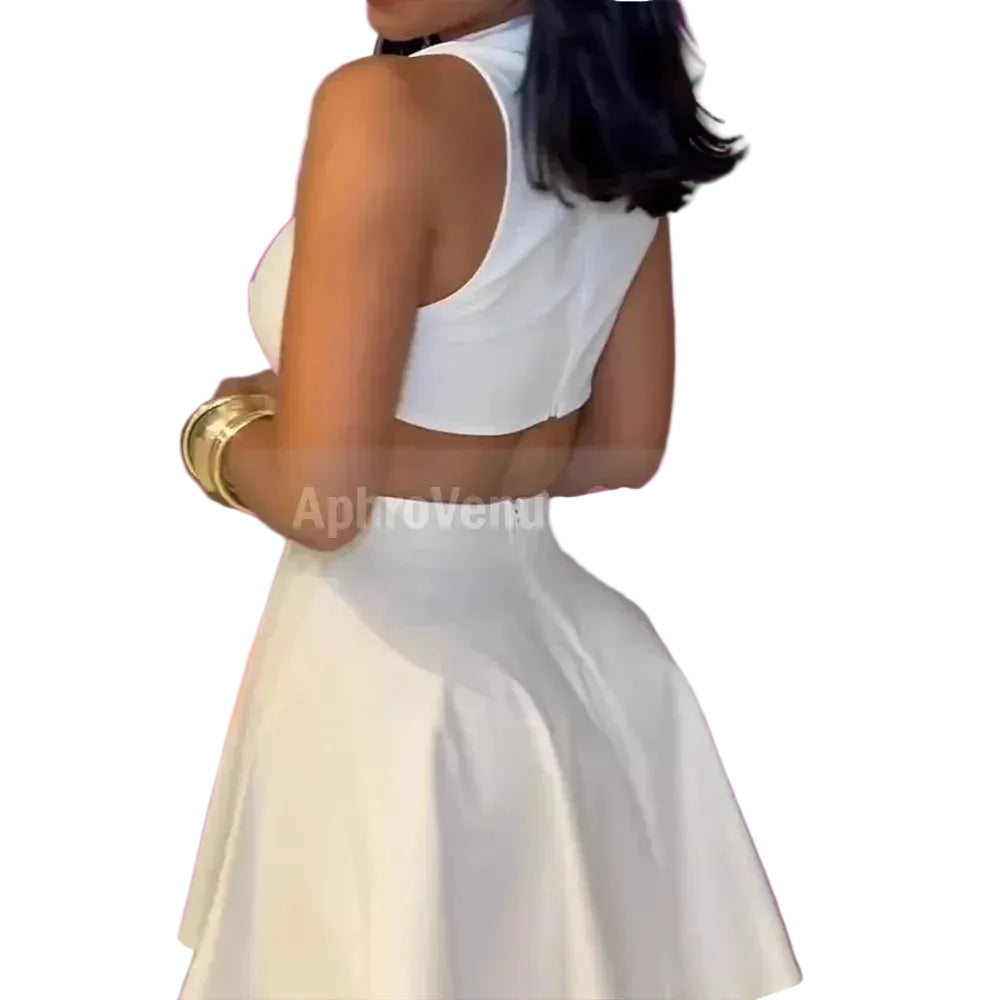 Woman in a white dress holding a yellow clutch against a neutral background